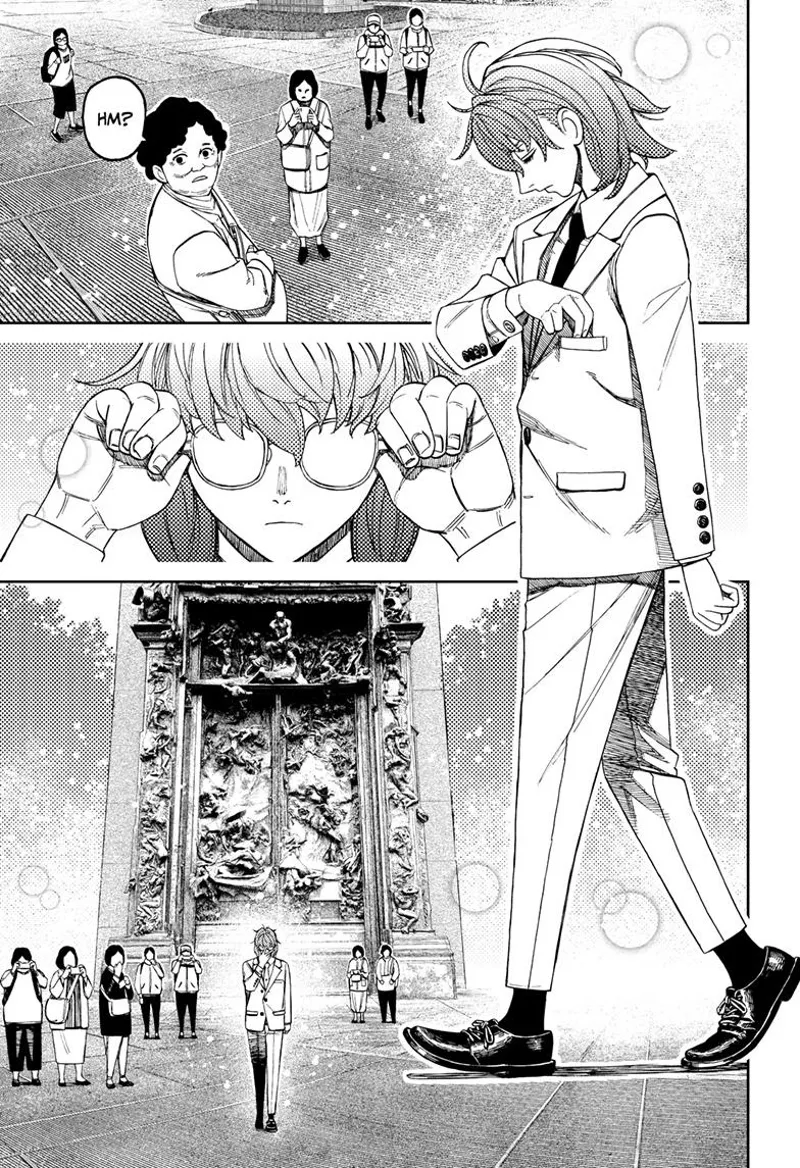 The man walks through and passes by the people who are staring at him.