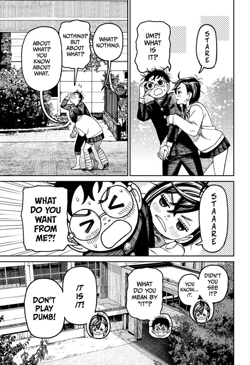 Momo playfully stares at Okarun while grabbing his arm. Okarun gets flustered.