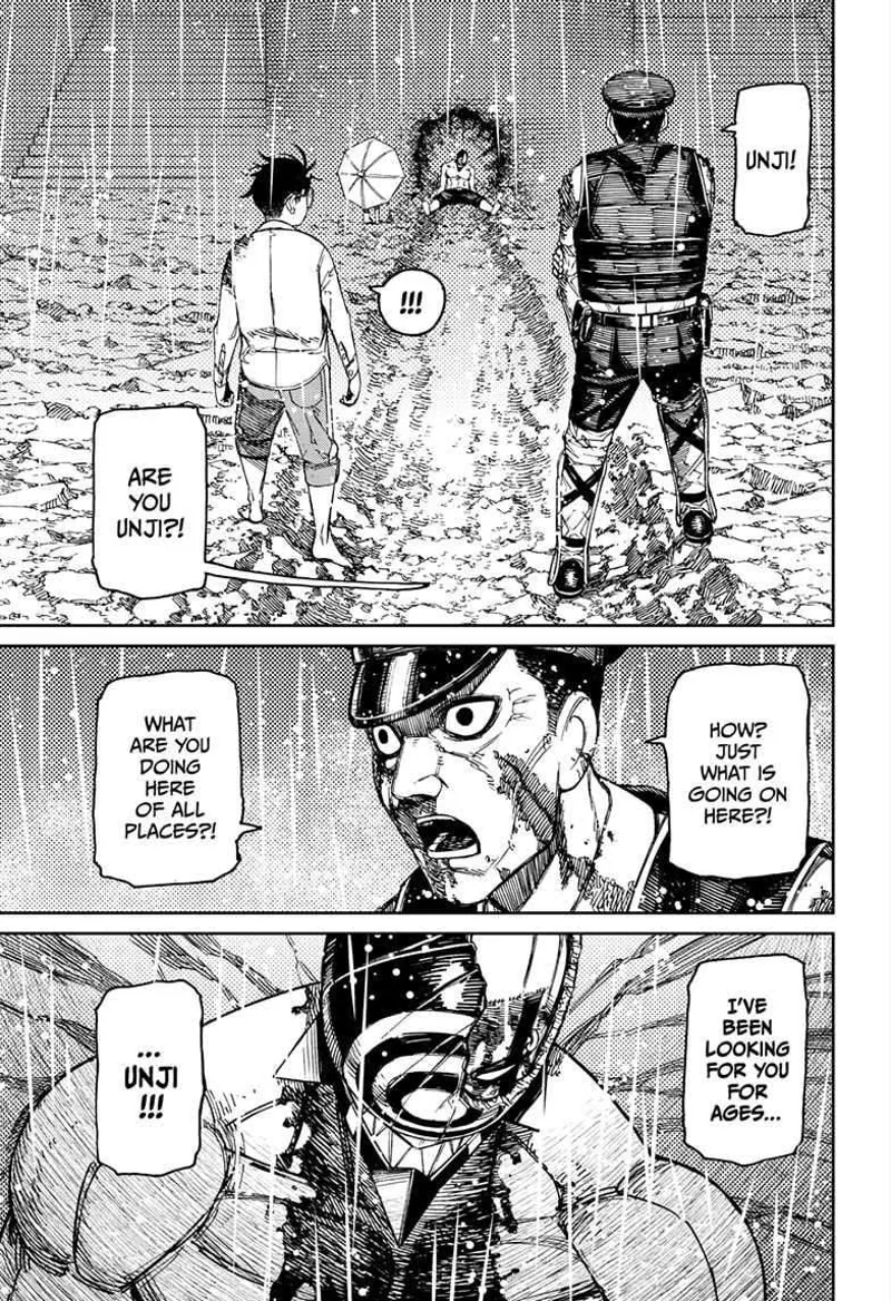 The police officer stands beside Okarun and recognizes Unji Zuma. He is surprised to see him there.