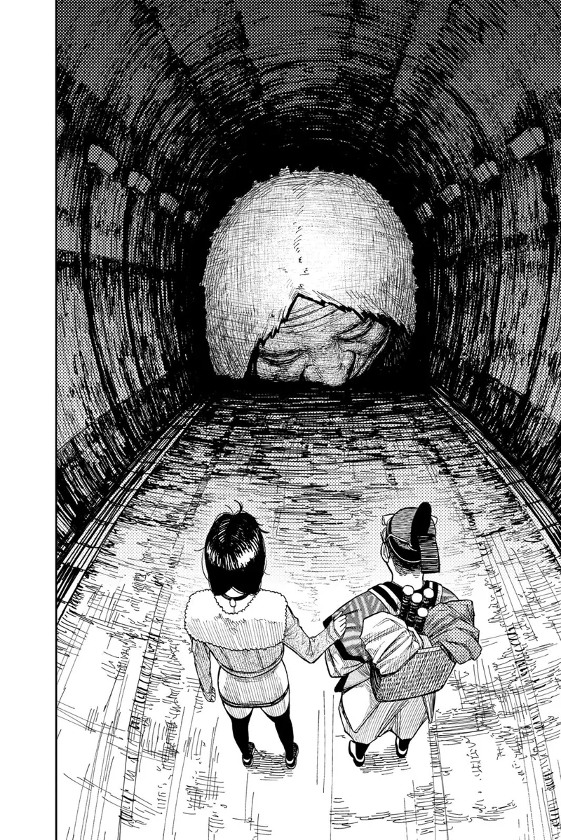 A huge granny head facing the ground appears, blocking the tunnel in front of Okarun and Momo.