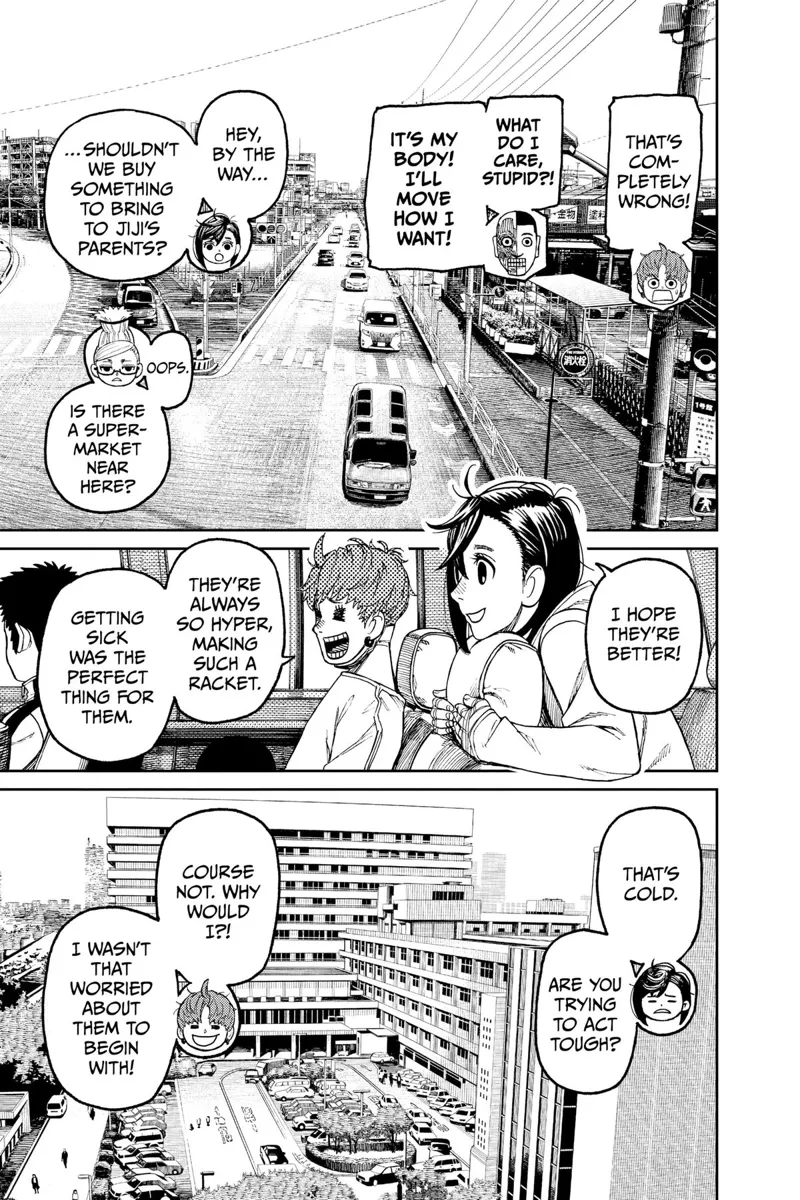 Their car drives through the road, in the middle of the city, and with other cars nearby.