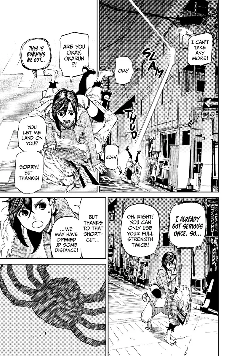 Okarun and Momo crash into a nearby building and land on a street. They survive and start running again.