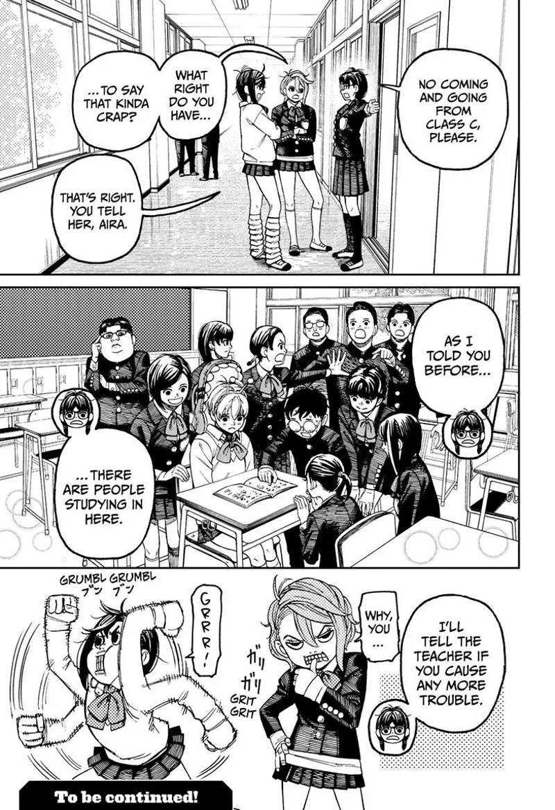 The student prevents Momo and Aira from entering the room. Inside, Okarun teaches Vamola while surrounded by other students.