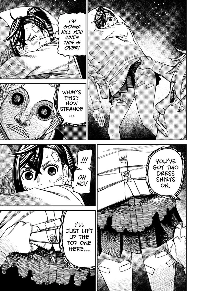 The man notices two dress shirts and decides to lift up one of them.