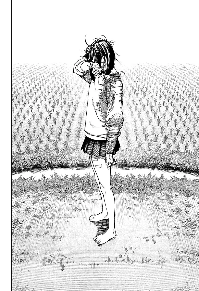 Momo stands alone, putting her arm to her eyes as she cries.